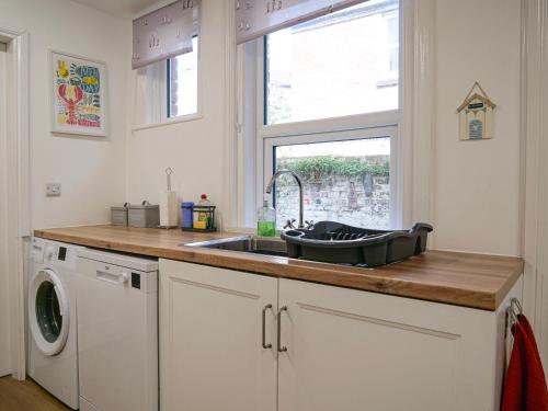a kitchen counter with a sink and a window at Seashells in Bridlington