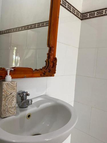 a white sink in a bathroom with a mirror at Sakti OceanView Nusa Penida in Nusa Penida