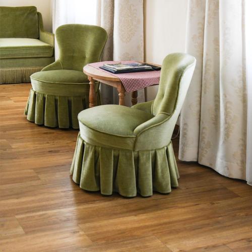 two chairs and a table in a room with a table at Landhotel Adler in Deggenhausertal
