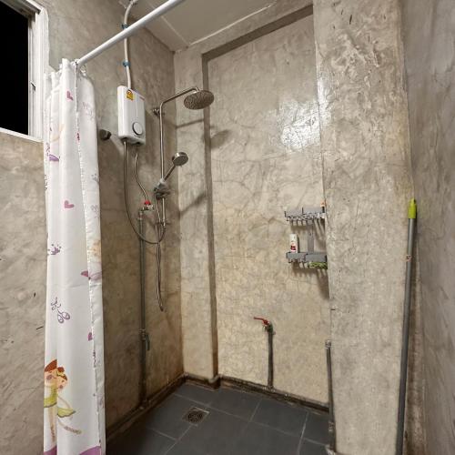 a shower with a shower curtain in a bathroom at 소다호스텔 Soda HosteL in Chiang Mai