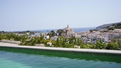 a swimming pool with a view of a city at Arrels Hotel Cadaques - Adults Only in Cadaqués