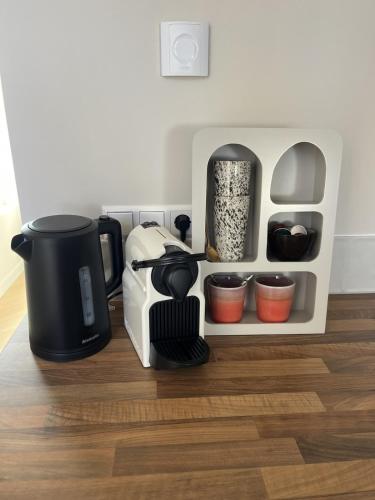 a coffeemaker sitting on top of a wooden floor at Salty Breeze in Noordwijk