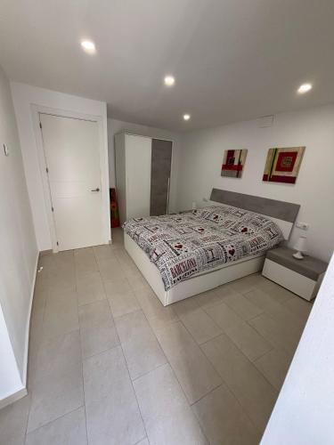 a bedroom with a bed and a tiled floor at Angel 29 in Vinarós