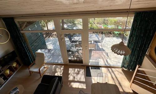 a view of a living room with a large window at Vieux Sart 34, chez Dame Béa in Stavelot
