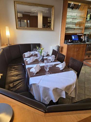 a dining room with a table with a white table cloth at Hotel Sonne Post in Murrhardt