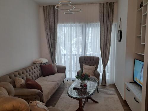 a living room with a couch and a table at Ruža Vetrova 4 in Nova Varoš