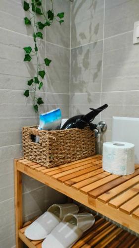 a basket on top of a wooden shelf with toiletries at N&K Yellow Pearl Flat in Volos
