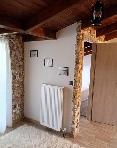 a room with a radiator and a stone wall at The view attic in Ioannina