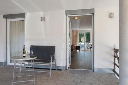 a living room with a table and a dining room at Gästehaus D i c k r e i t e r in Immenstaad am Bodensee