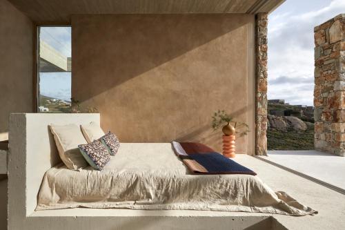 a bedroom with a bed and a large window at Perma Serifos in Serifos Chora
