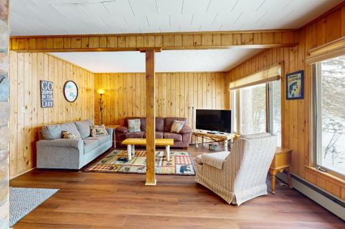 a living room with a couch and a tv at Timberlane Lodge- The Musky, Bluegill & Walleye in Woodruff