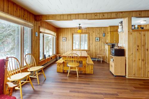 a kitchen and dining room with a table and chairs at Timberlane Lodge- The Musky, Bluegill & Walleye in Woodruff