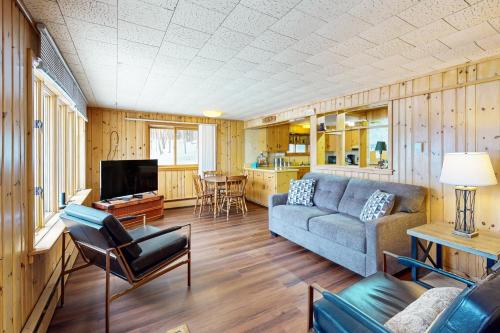 a living room with a couch and a tv at Timberlane Lodge- The Musky, Bluegill & Walleye in Woodruff