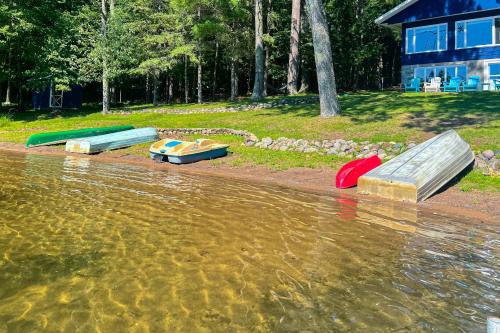 three boats sitting on the shore of a body of water at Timberlane Lodge- The Musky, Bluegill & Walleye in Woodruff