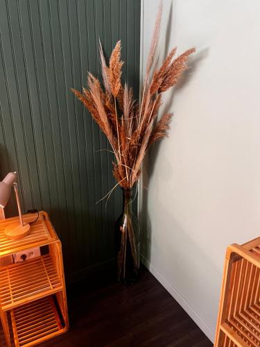 a vase with a plant in it next to a wall at Hôtel Fleur des Alpes in La Brigue