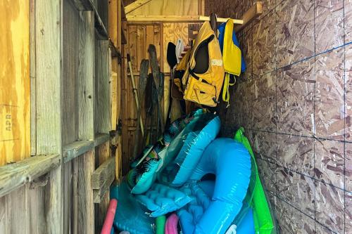 a group of inflatable kayaks are lined up against a wall at Timberlane Lodge- The Musky, Bluegill & Walleye in Woodruff