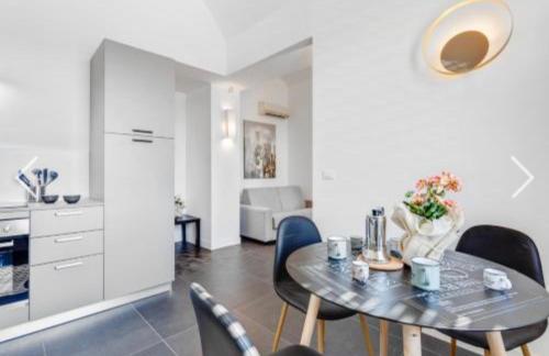 a kitchen and dining room with a table and chairs at EUREKA APArtment in Catania