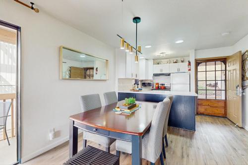 a kitchen and dining room with a table and chairs at Banyan Harbor I-101 in Lihue