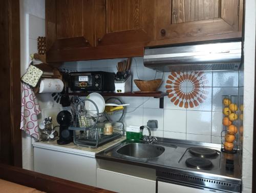 a kitchen with a sink and a counter top at Fiocco di sole Apartment in Sestriere