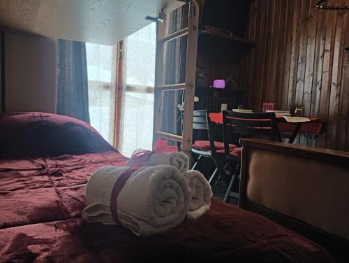 a bedroom with a bed with a towel on it at Fiocco di sole Apartment in Sestriere