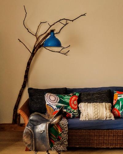 a blue lamp sitting on top of a blue couch at Studniska Country Estate in Studniska