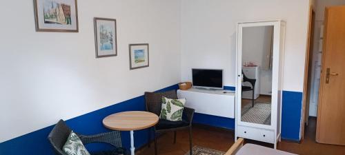 a small room with a table and a mirror at Appartements an der Kaiserpfalz - Königshof in Forchheim