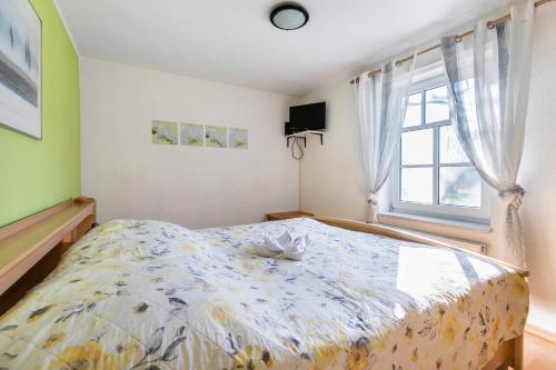 a bedroom with a large bed and a window at Hus Tingeltut Gerd Clausen in Pellworm