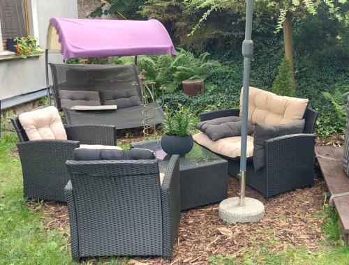 a group of chairs and an umbrella in a yard at Vila Kost in Sobotka