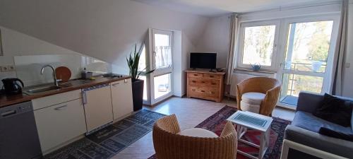 a kitchen with a sink and a table with chairs at Appartements an der Kaiserpfalz - Königshof in Forchheim