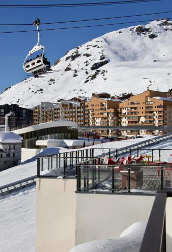 a ski resort in the snow with a ski lift at Hôtel Val Chavière in Val Thorens