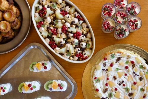 a table topped with trays of food and pies at Hôtel Val Chavière in Val Thorens