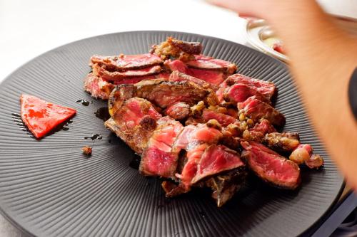 a plate of food with meat and nuts on it at Hotel Serawa Moraira in Moraira