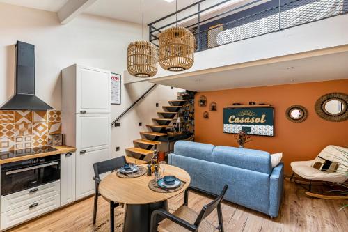 un salon avec un canapé bleu et une table dans l'établissement CasaSol - Lyon PartDieu, à Lyon