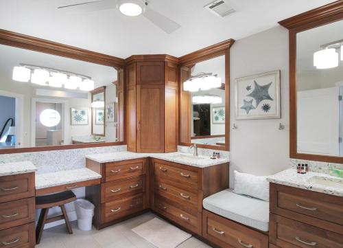 a bathroom with two sinks and a large mirror at Bayfront 3BR 2nd floor Siesta Key condo with private beach access in Siesta Key