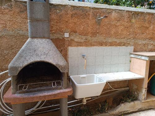 a brick oven with a sink on a table at The Dreams House Mondello in Mondello