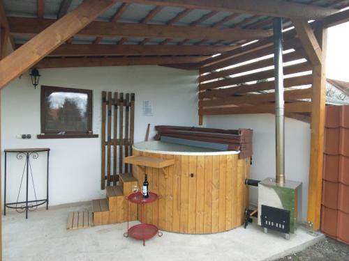 a room with a bar and a wood stove at Sziget Gyöngye Vendégház in Tahitótfalu