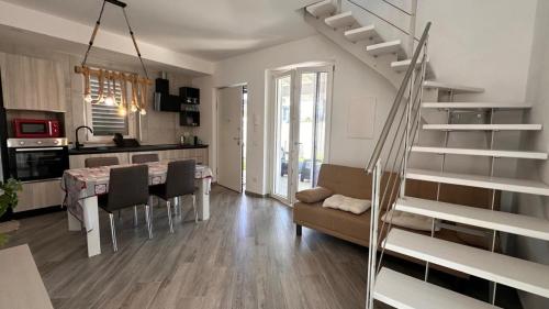 a living room with a staircase and a dining room at VILLA SABRINA VICINA al MARE in Terracina