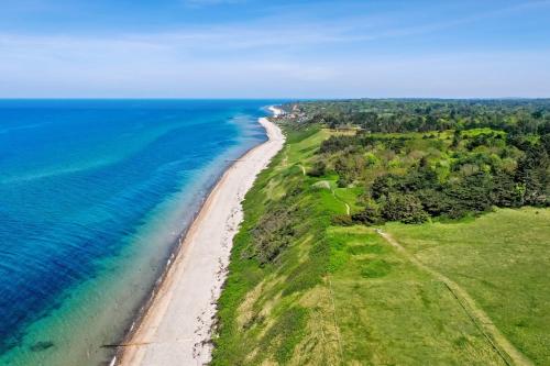 an aerial view of a beach and the ocean at Vejby Strand cabin near beach & Heatherhill - 101 m2 in Vejby