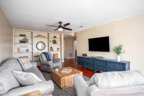 a living room with two couches and a flat screen tv at King Beds Game Room On 290 Large Estate Kitchen in Fredericksburg