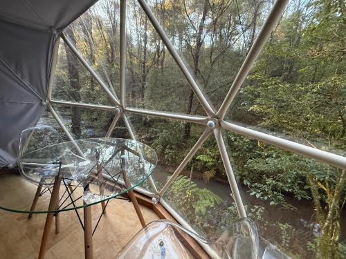 a room with a table and a view of a forest at MANDALA CAMP in Tomatlán