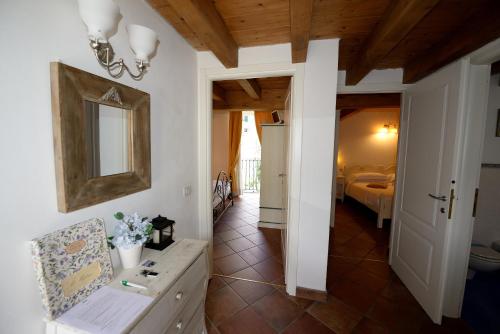 a hallway with a room with a bed and a mirror at Il Mulino di Hotel Villa Aurora in Nesso