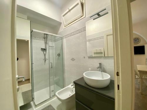 a bathroom with a sink and a glass shower at Casa Lorenz in Florence