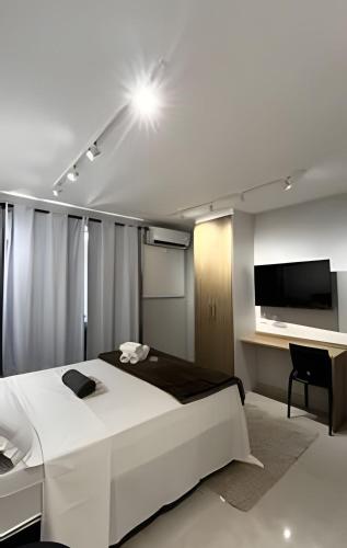 a bedroom with a bed and a flat screen tv at Conforto e Praticidade - Centro do RJ in Rio de Janeiro
