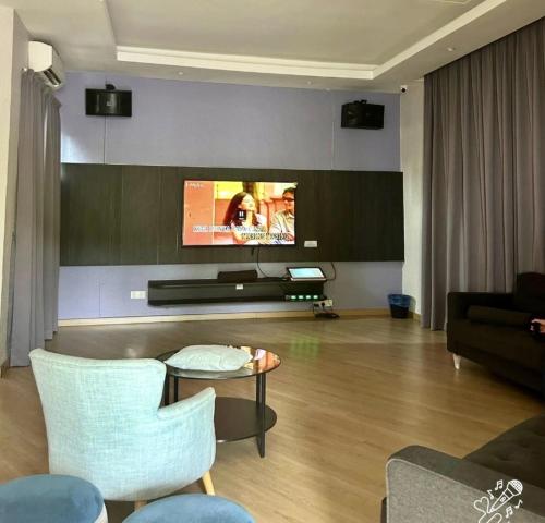 a living room with a couch and a tv at Twynstar Mutiara Melaka Beach Resort in Tangga Batu