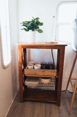 a small wooden table with bowls and dishes on it at Sunrise Serenity RV - Panoramic Views in Culebra