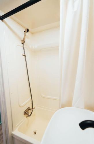 a shower in a small bathroom with a toilet at Sunrise Serenity RV - Panoramic Views in Culebra