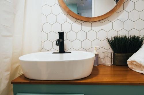 a bathroom with a white sink and a mirror at Sunrise Serenity RV - Panoramic Views in Culebra
