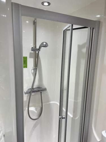 a shower in a bathroom with a glass door at Astor House by Pureserviced in Plymouth