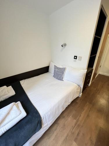 a bedroom with a large bed with white sheets at Astor House by Pureserviced in Plymouth