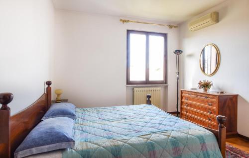 a bedroom with a bed and a dresser and a window at Gorgeous Home In Cisano Di Bardolino in Calmasino